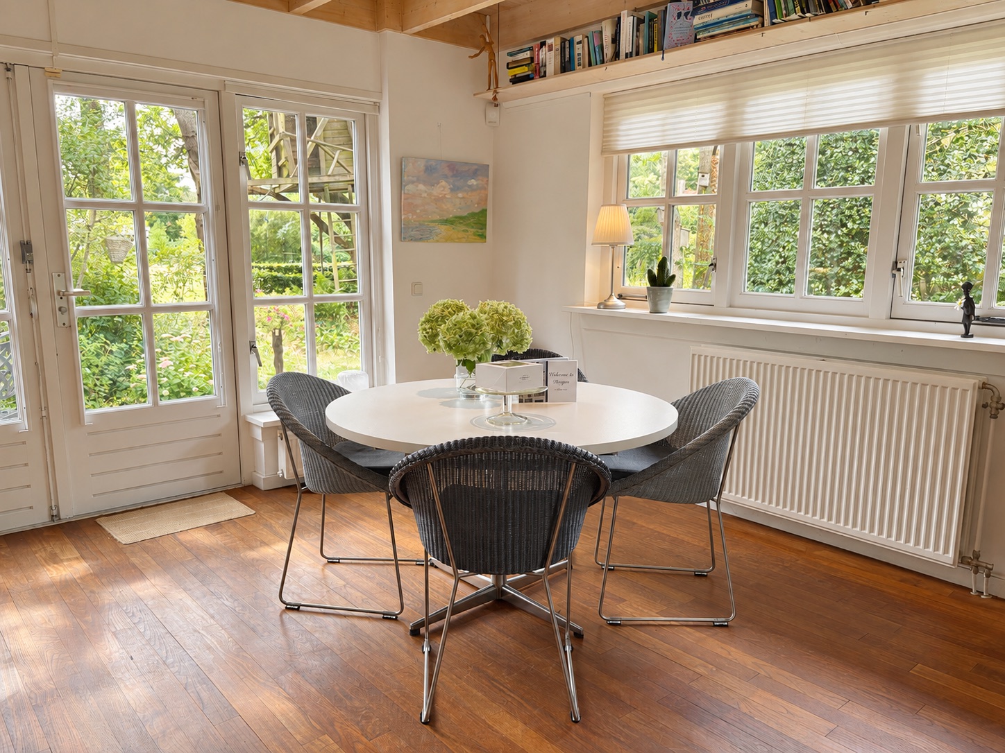 The dining area with a round table beside the garden doors