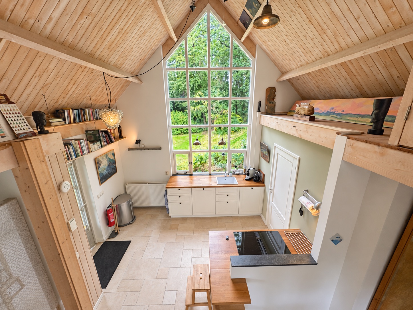 The kitchen beneath the tall studio window, overlooking the garden